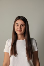 Photo of Beautiful young woman in white t-shirt on light background