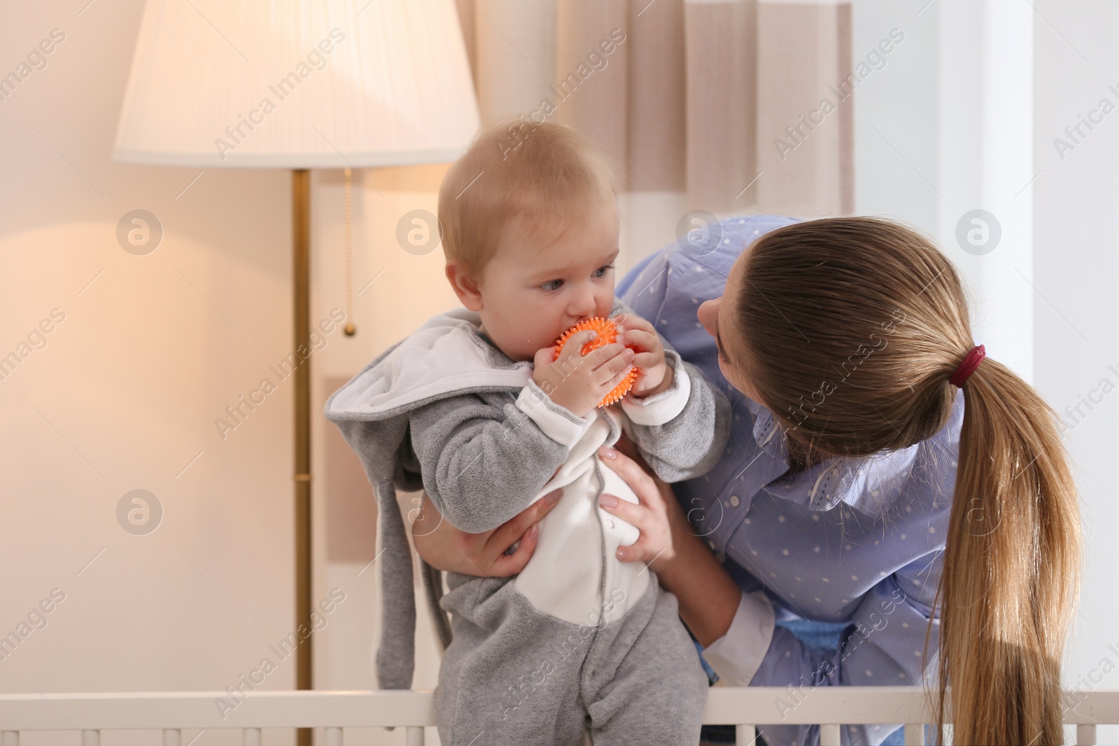 Photo of Teen nanny with cute little baby at home