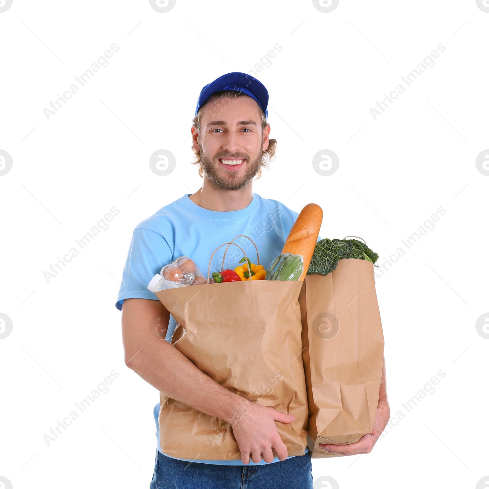 Photo of Delivery man holding paper bags with food products on white background