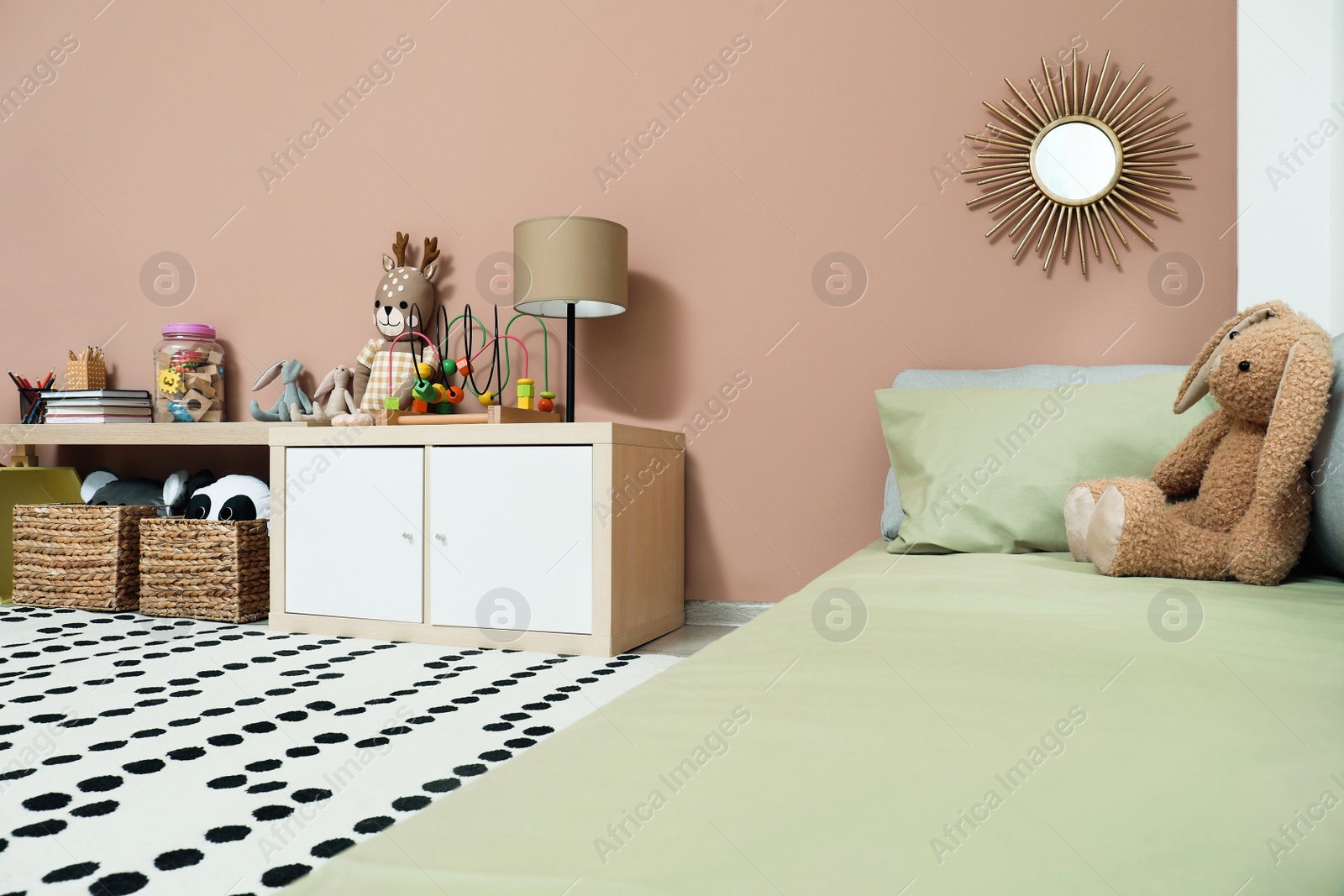 Photo of Montessori bedroom interior with floor bed and toys