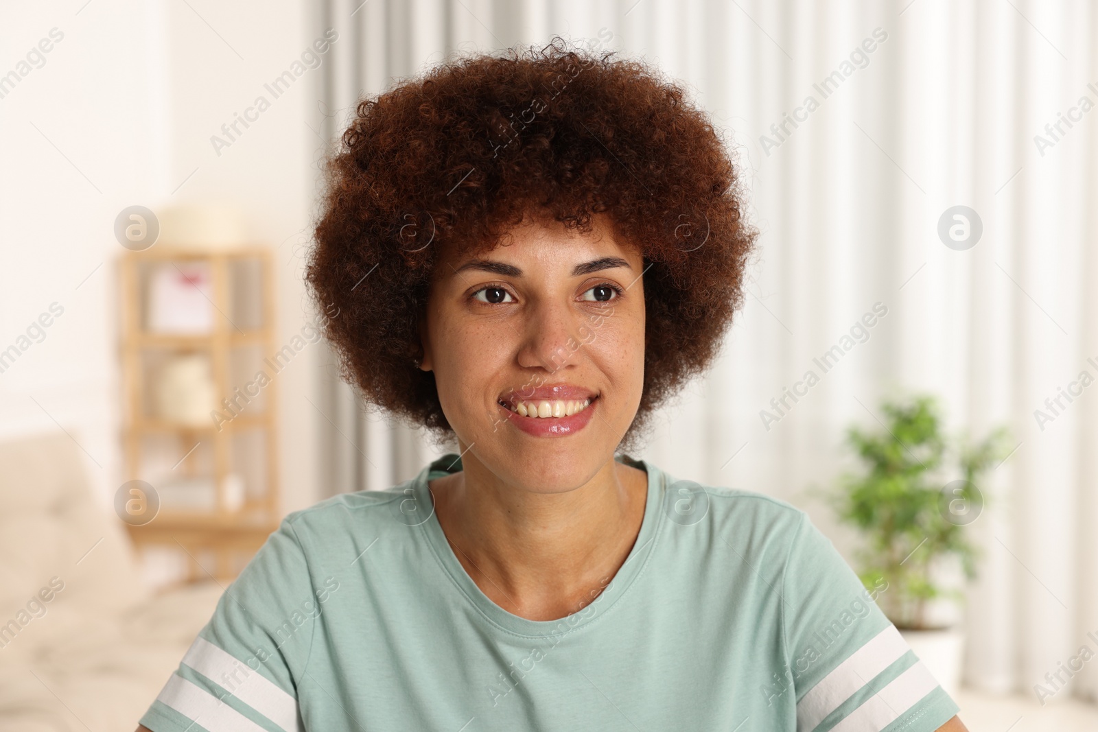 Photo of Portrait of happy young woman in room