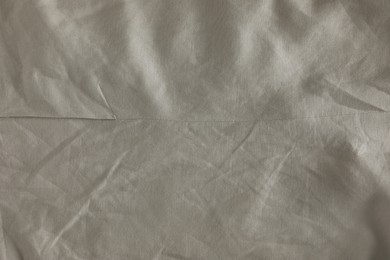 Crumpled dark beige fabric as background, top view