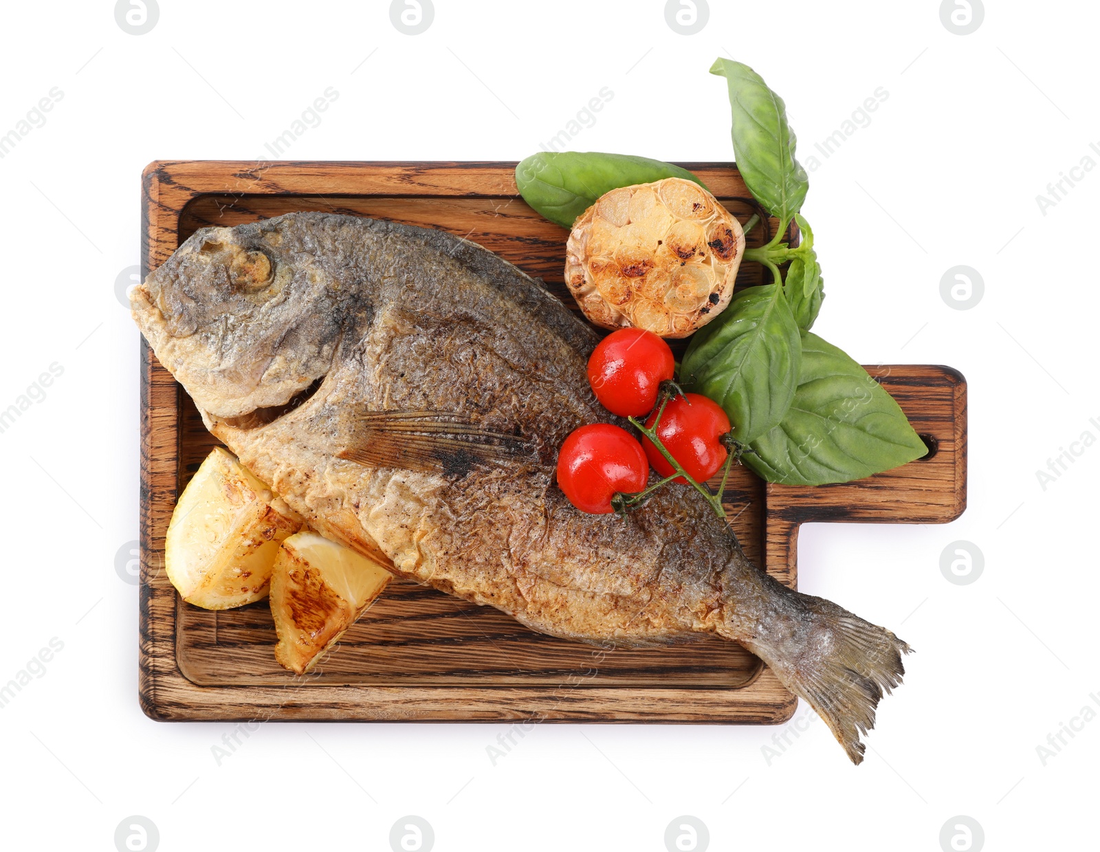 Photo of Delicious roasted dorado fish with vegetables, basil and lemon isolated on white, top view