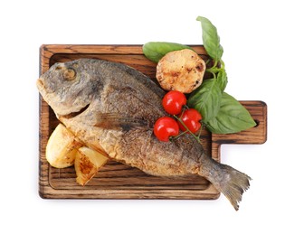 Photo of Delicious roasted dorado fish with vegetables, basil and lemon isolated on white, top view