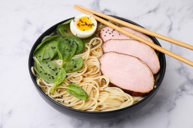 Photo of Delicious ramen with meat on white marble table, closeup. Noodle soup