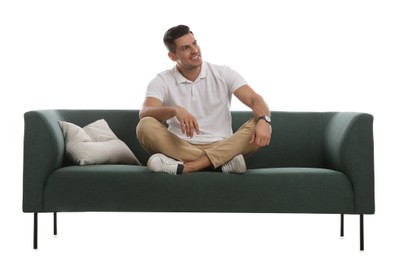 Man relaxing on comfortable green sofa against white background