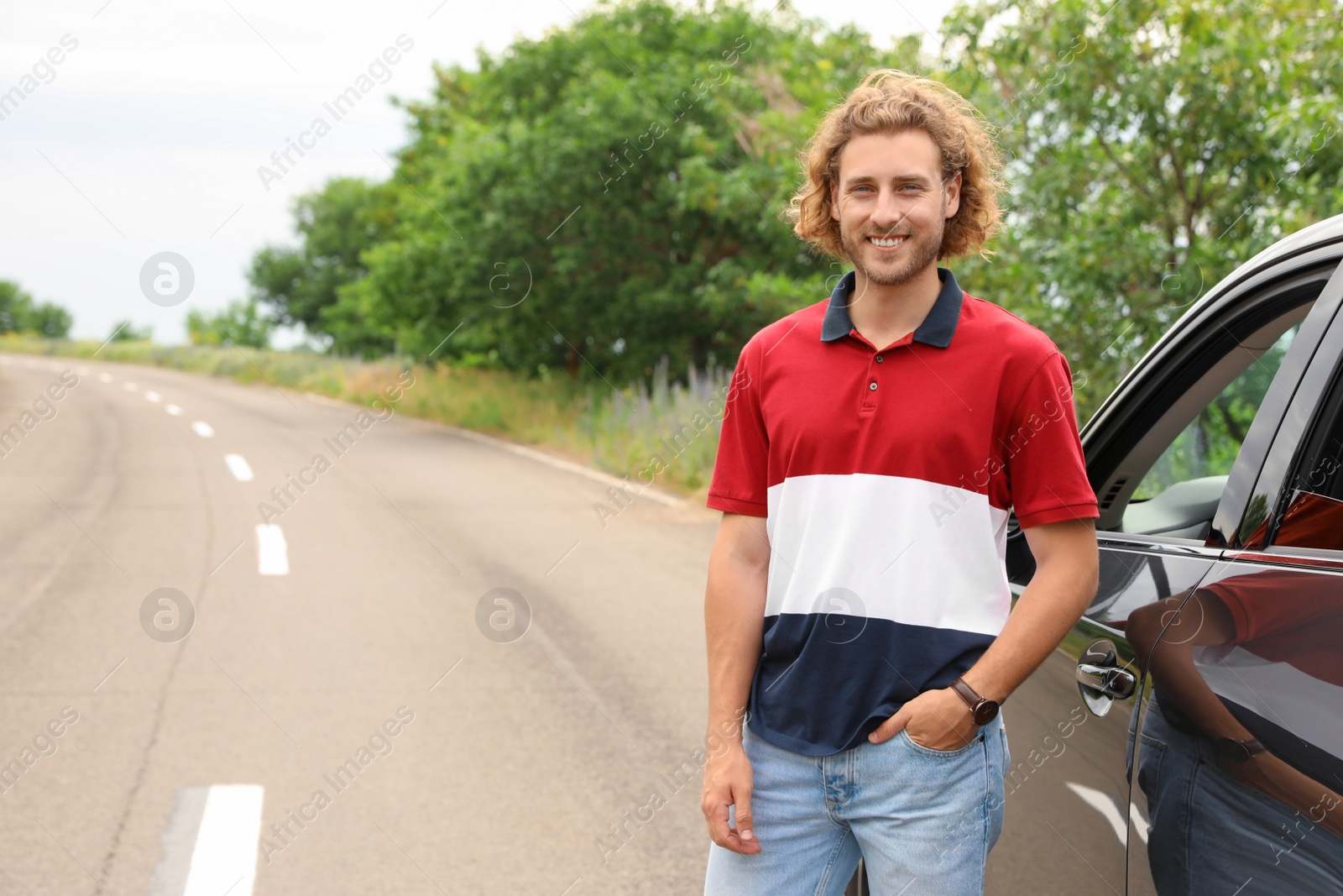 Photo of Attractive young man near luxury car outdoors