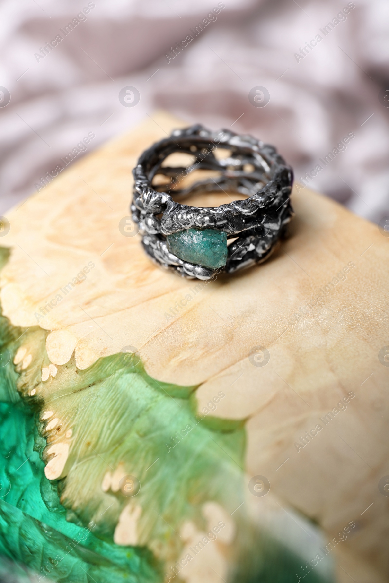 Photo of Beautiful silver ring with apatite gemstone on color background. Space for text