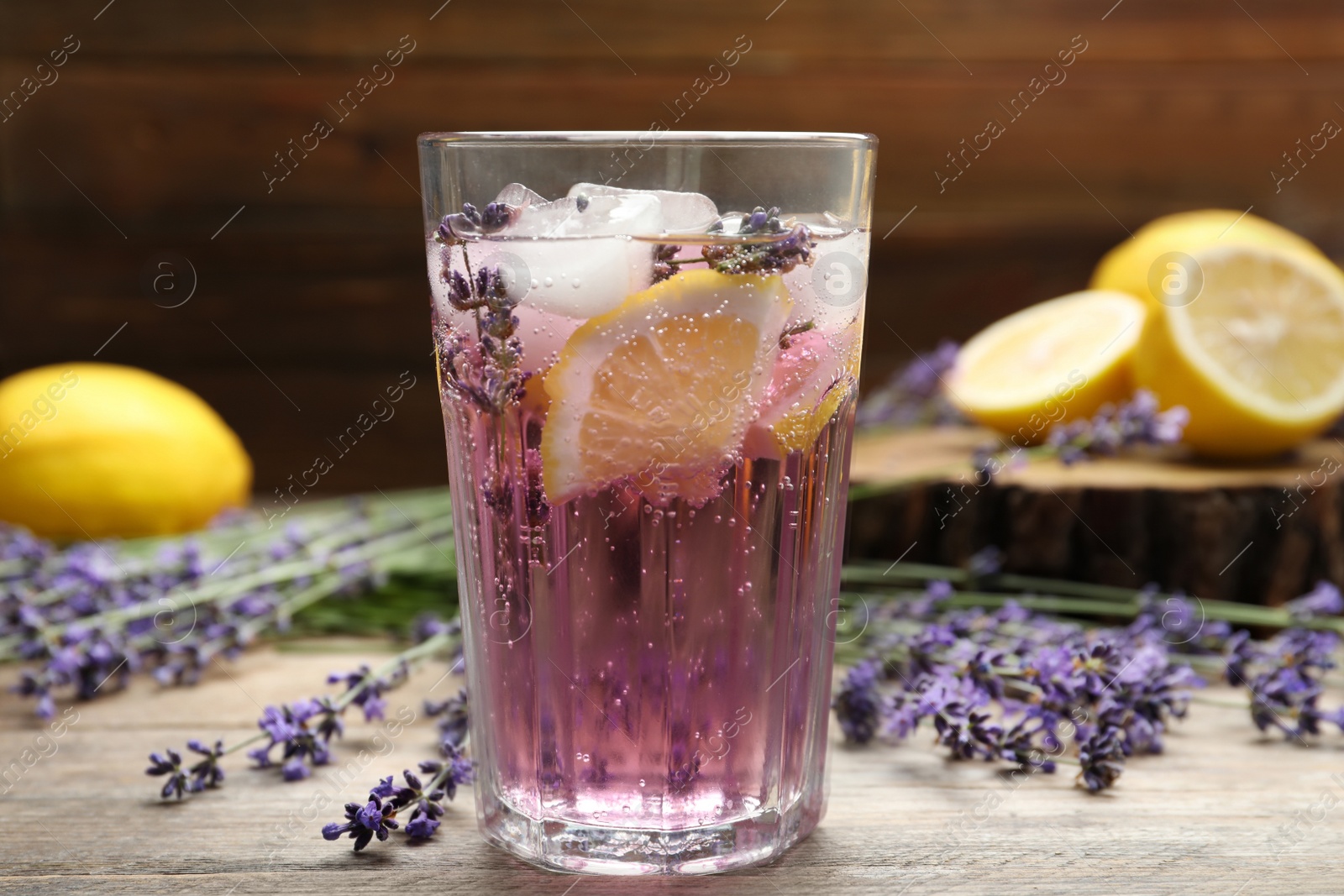 Photo of Fresh delicious lemonade with lavender on wooden table