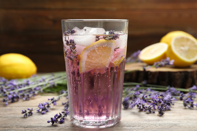 Photo of Fresh delicious lemonade with lavender on wooden table