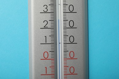 Photo of Weather thermometer on light blue background, closeup