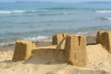 Photo of Beautiful sand castle on beach near sea