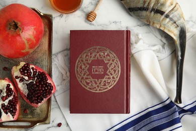 Photo of Flat lay composition with Rosh Hashanah holiday symbols on white marble table