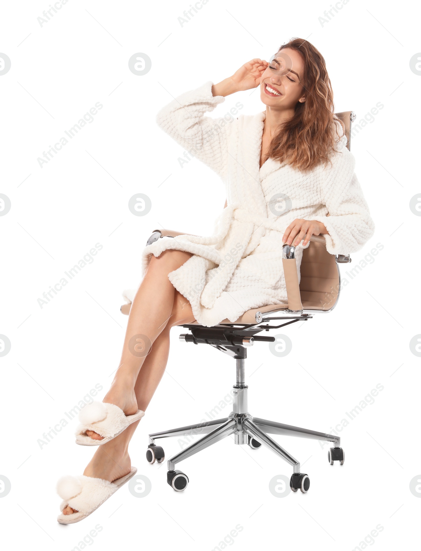 Photo of Beautiful young woman wearing bathrobe sitting in chair on white background