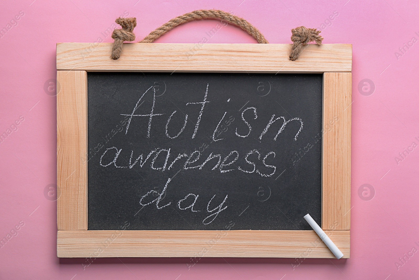 Photo of Chalkboard with phrase "Autism awareness day" on color background