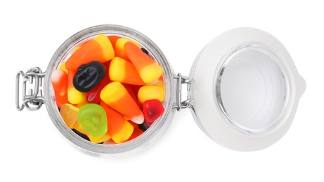 Jar of delicious colorful candies isolated on white, top view. Halloween sweets