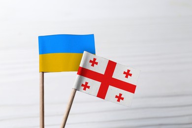 Image of National flags of Ukraine and Georgia on white blurred background