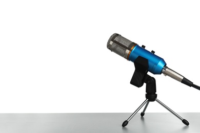 Photo of Microphone on table against white background. Space for text