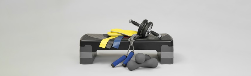 Image of Step platform and other sport equipment on light background. Banner design