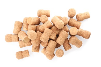 Photo of Heap of sparkling wine corks on white background, top view