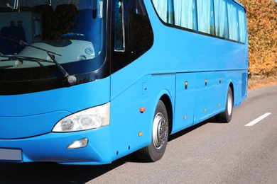 Photo of Modern blue bus on road. Passenger transportation