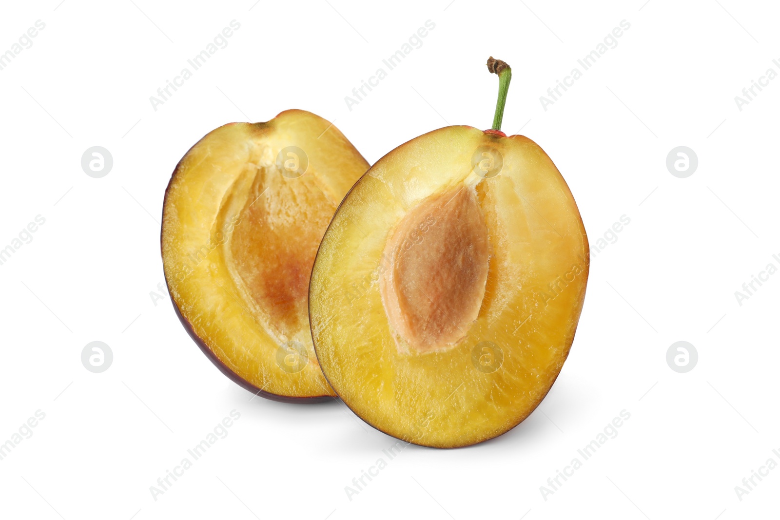 Photo of Halves of fresh ripe plum on white background