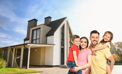 Image of Happy family smiling near their new house