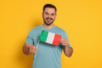 Man with flag of Italy on yellow background