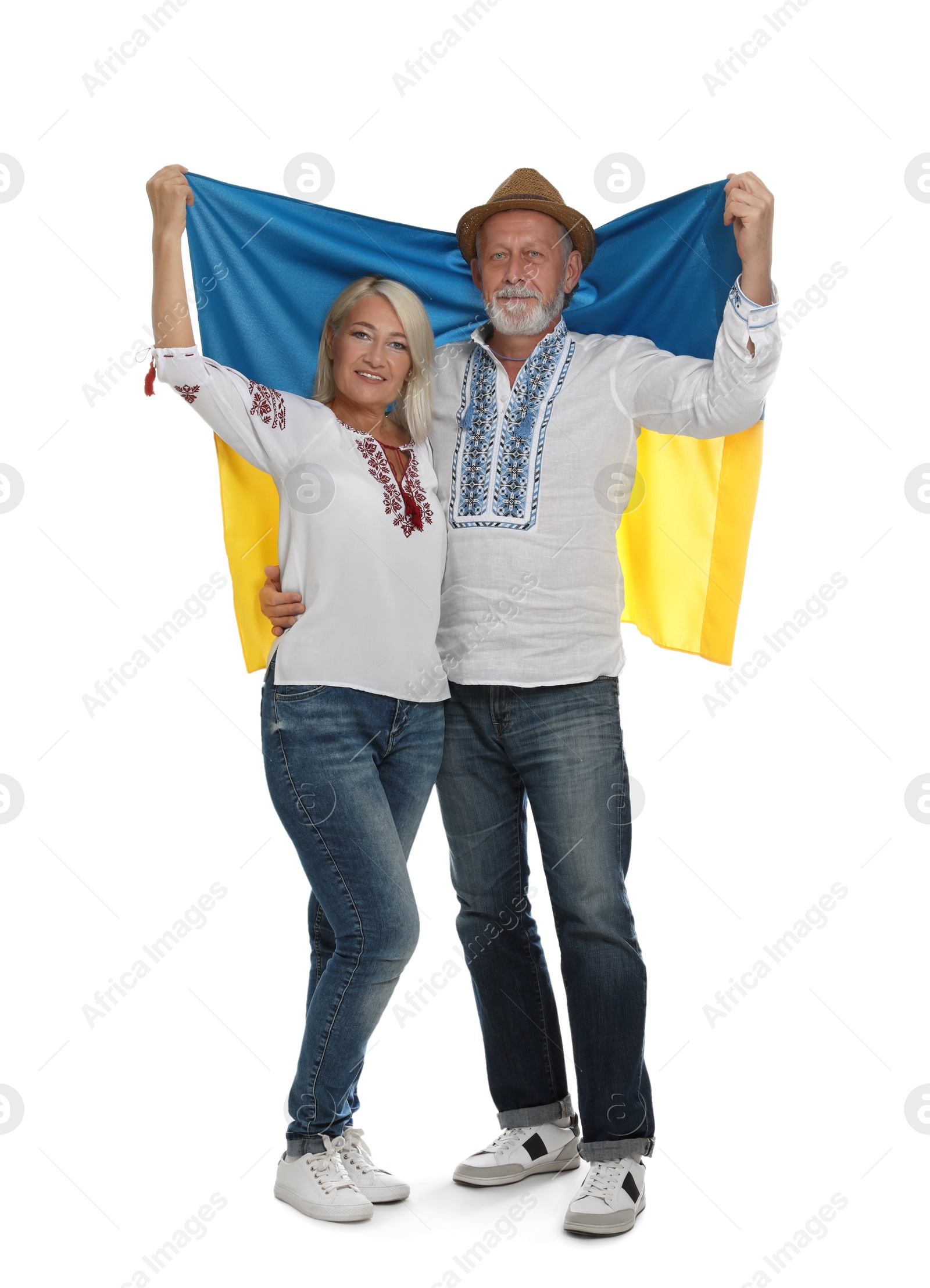 Photo of Happy mature couple with national flag of Ukraine on white background