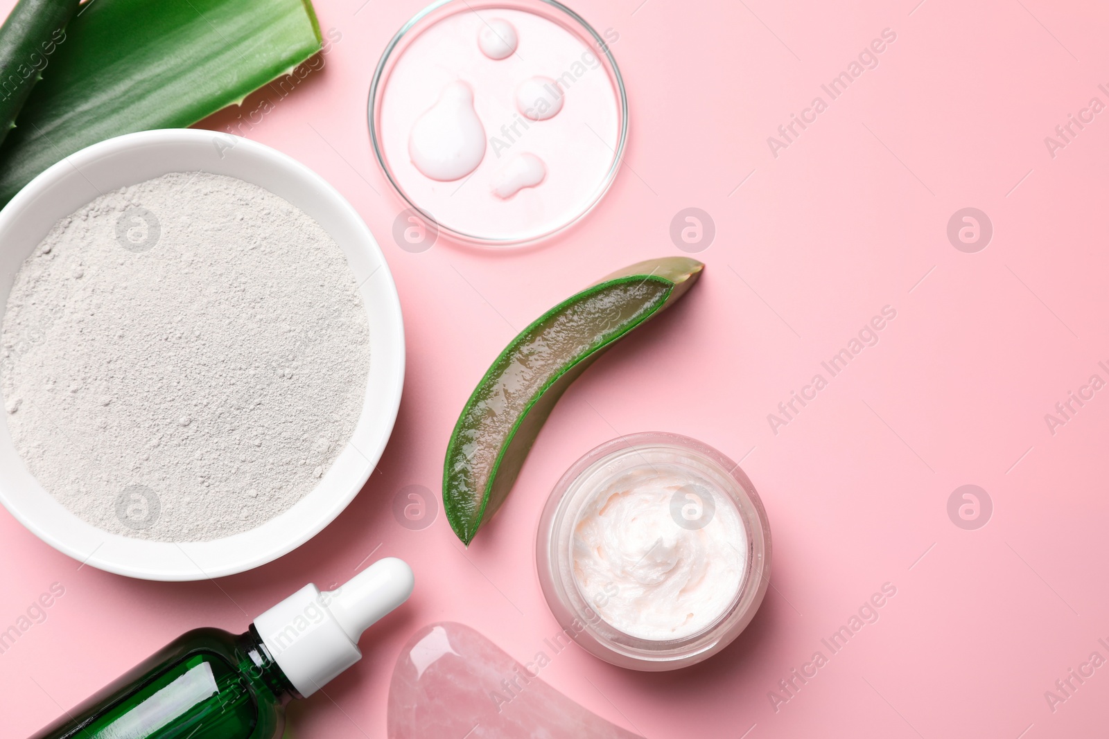 Photo of Flat lay composition with cosmetic products and cut aloe leaves on pink background. Space for text