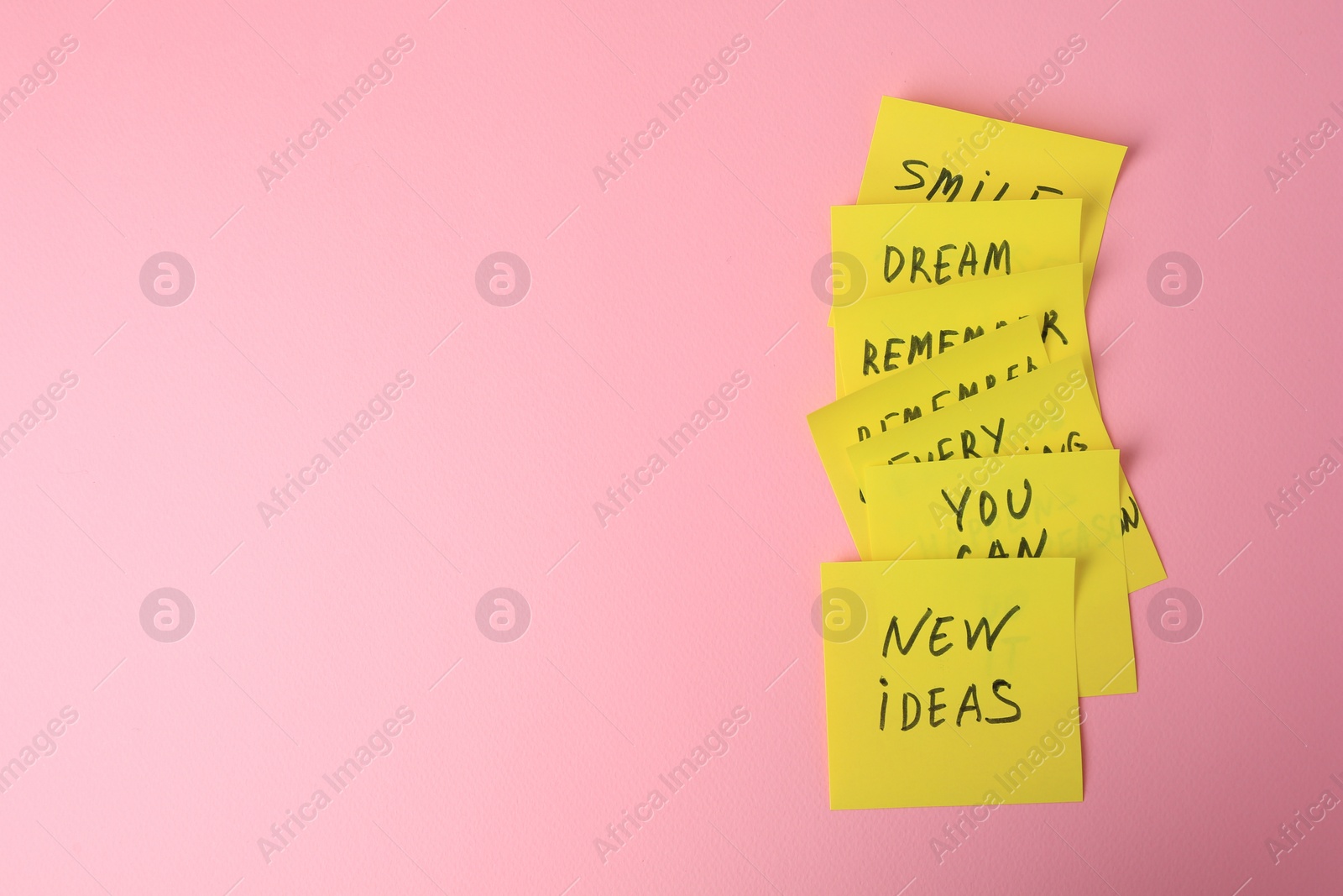 Photo of Paper notes with life-affirming phrases on pink background, flat lay. Space for text