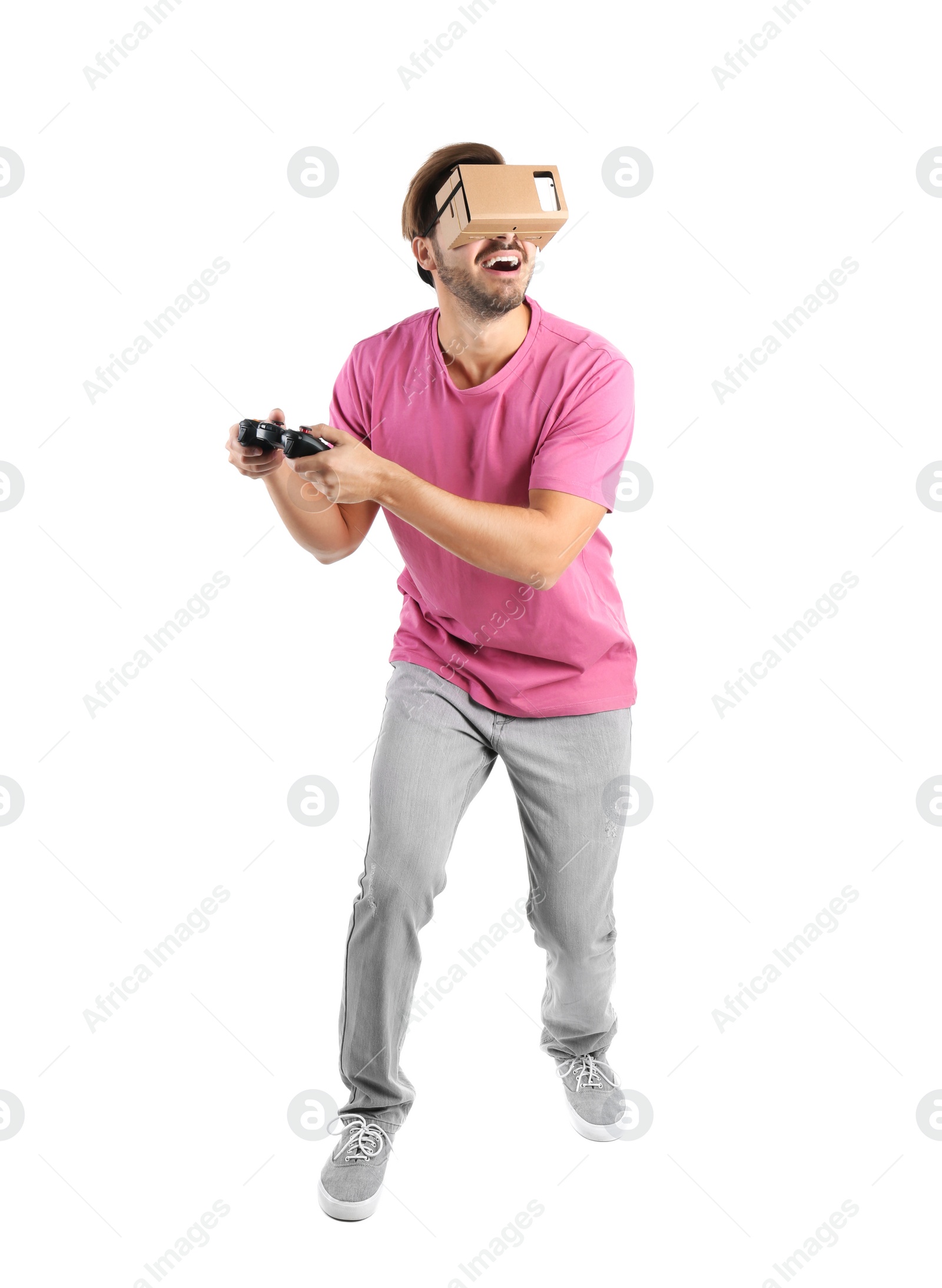 Photo of Young man using cardboard virtual reality headset, isolated on white