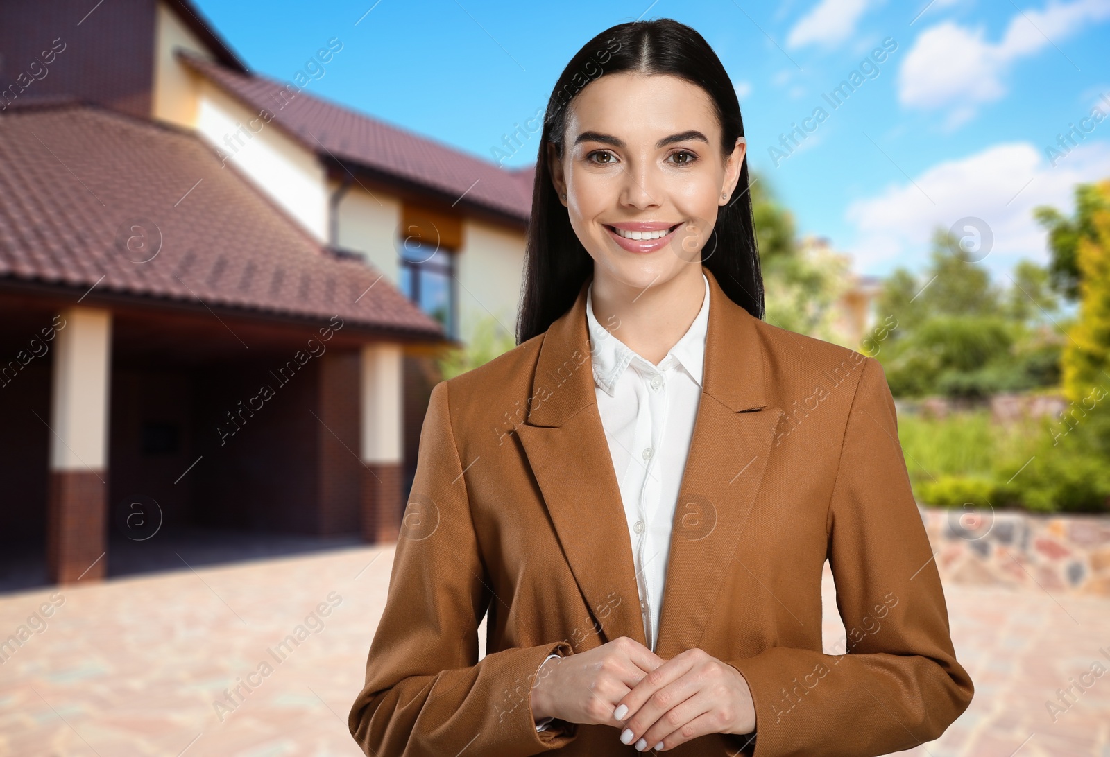 Image of Smiling real estate agent near beautiful house outdoors. Space for text