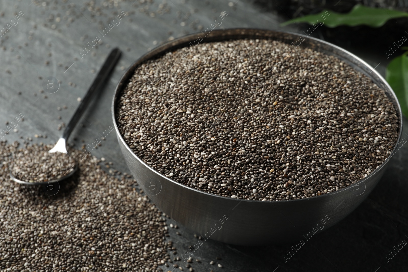 Photo of Metal bowl with chia seeds on table