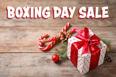 Image of Text Boxing Day Sale and Christmas gift on wooden table