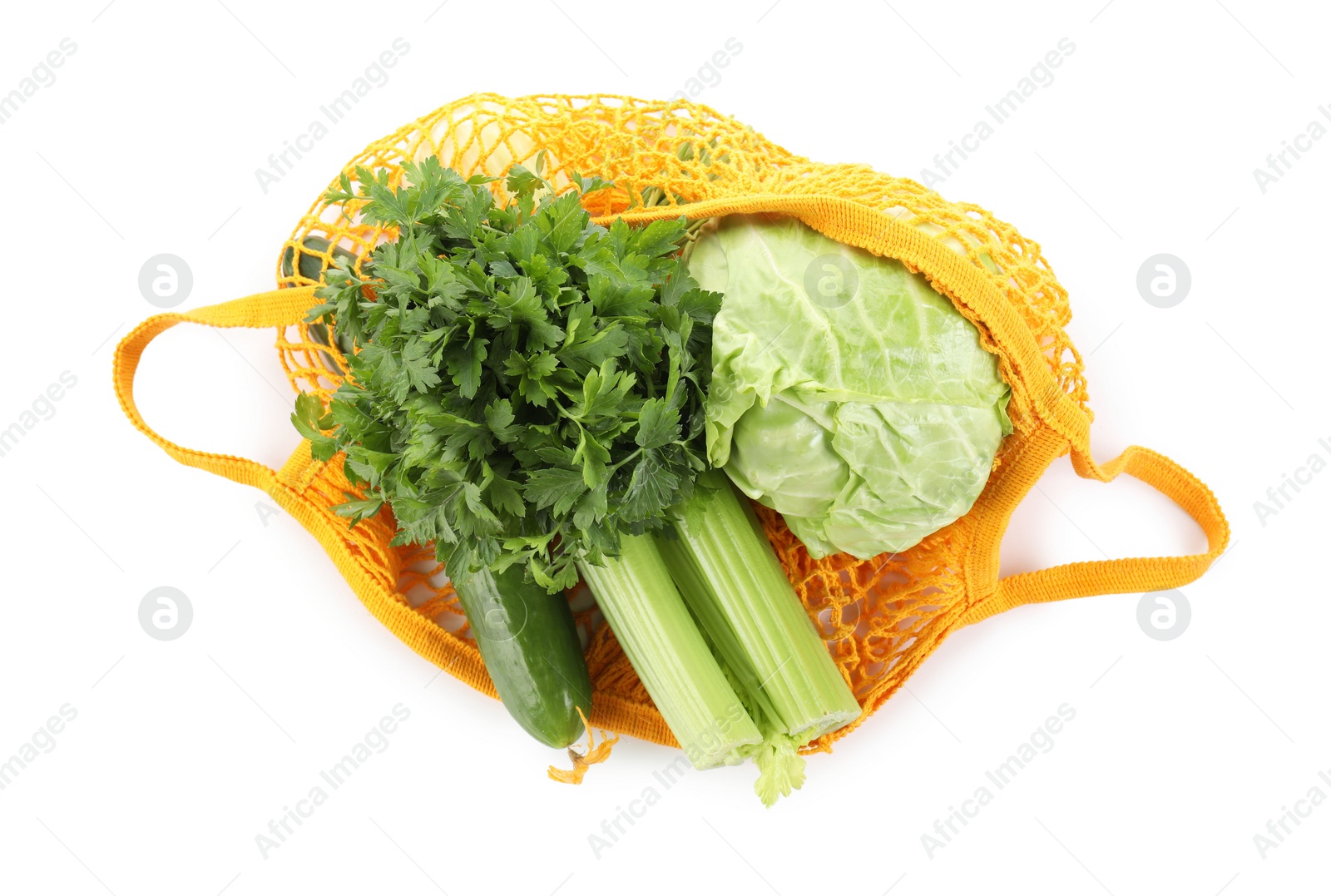 Photo of String bag with different vegetables isolated on white, top view