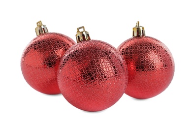 Beautiful shiny red Christmas balls on white background