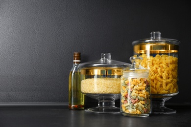 Photo of Products in modern kitchen glass containers on black table