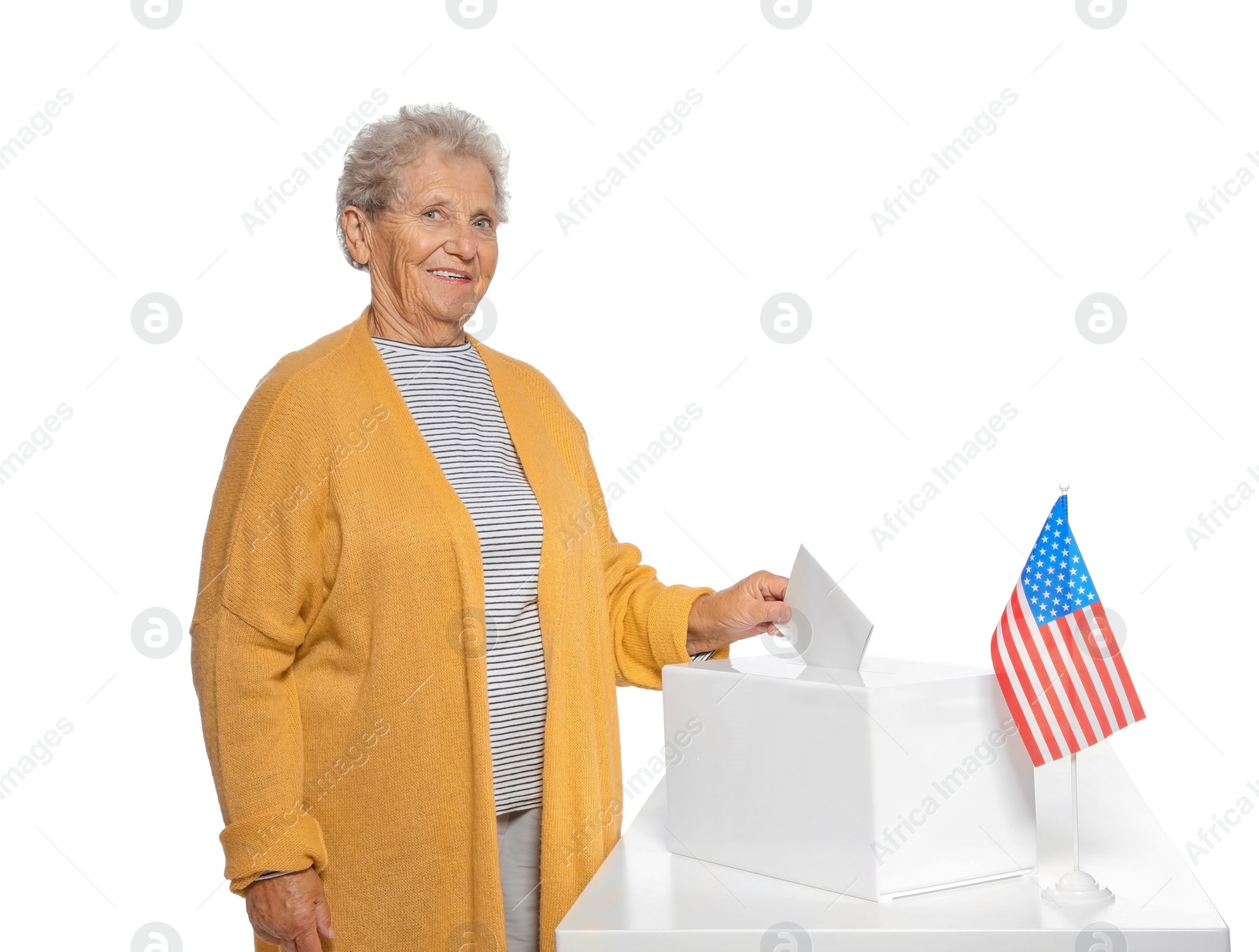 Photo of Elderly woman putting ballot paper into box against white background