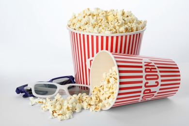 Photo of Fresh popcorn and 3D glasses on white background. Cinema snack