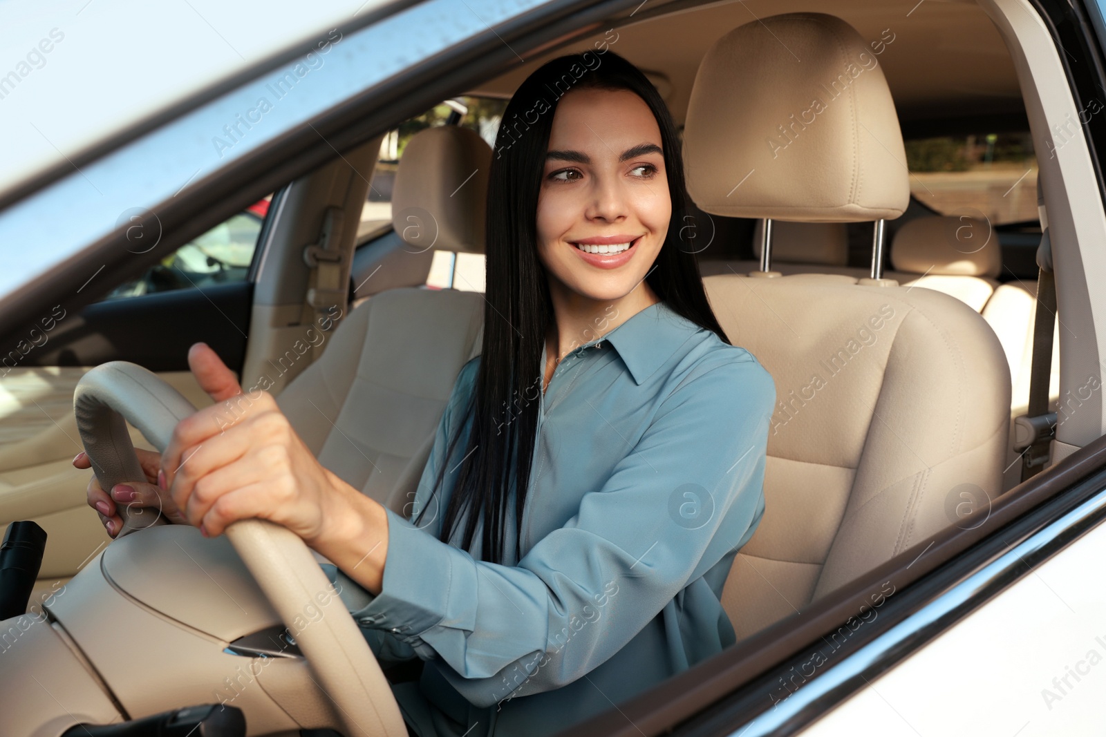 Photo of Beautiful young driver sitting in modern car