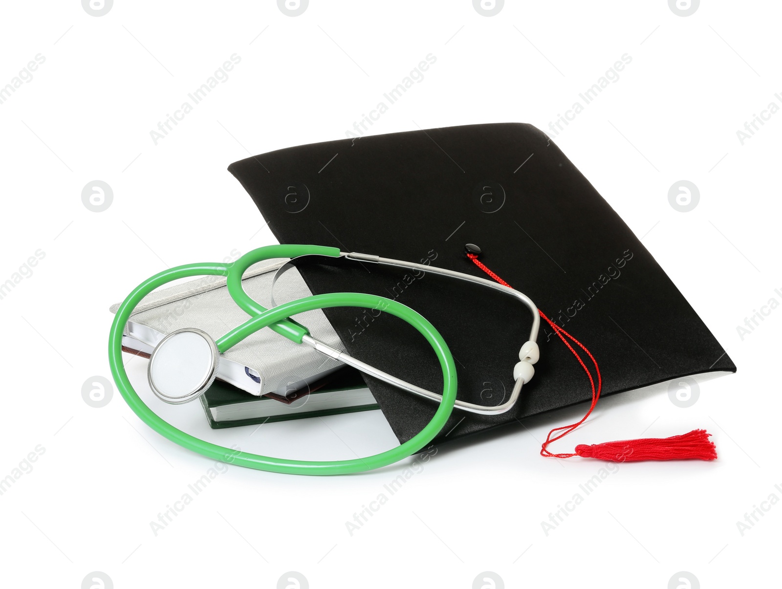 Photo of Stethoscope notebooks and graduation hat on white background. Medical students stuff