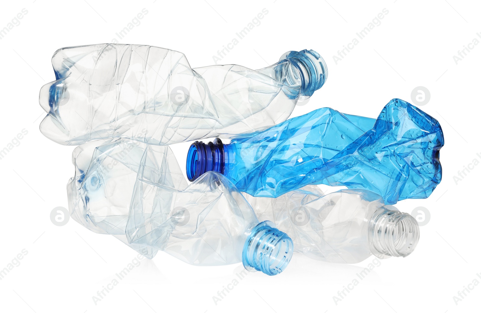 Photo of Crumpled disposable plastic bottles isolated on white