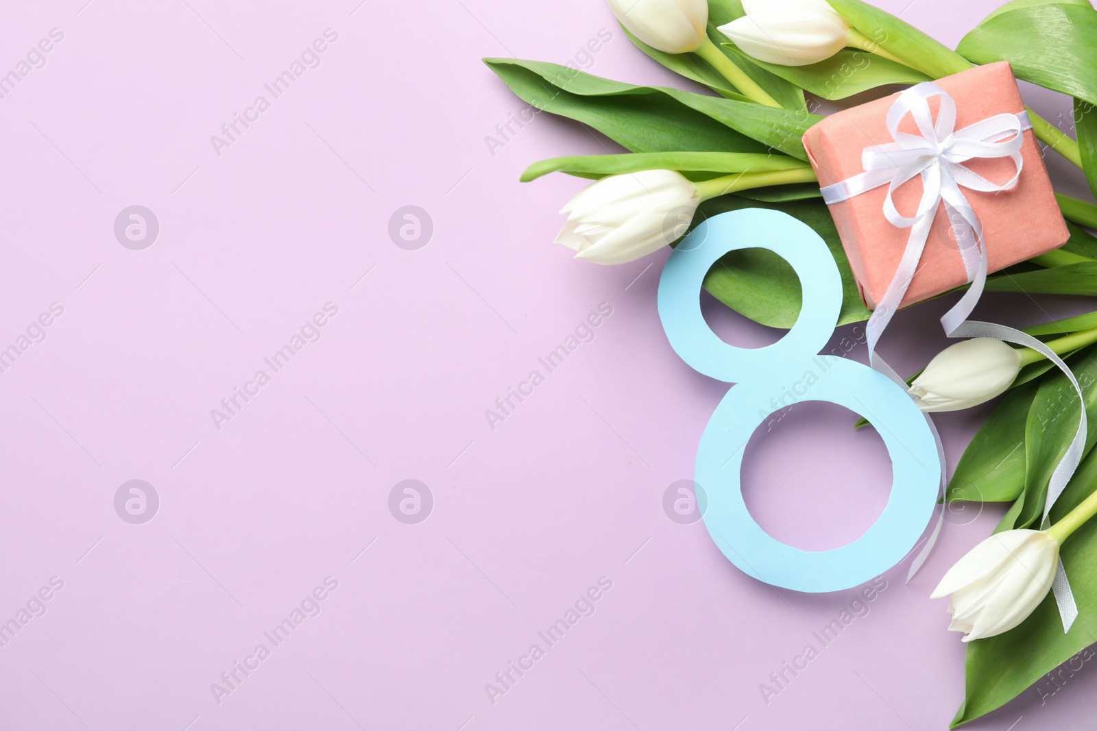 Photo of 8 March card design with tulips, gift and space for text on violet background, flat lay. International Women's Day