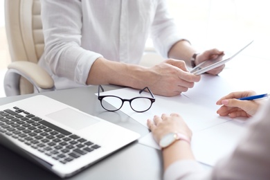 Photo of Human resources manager conducting job interview with applicant in office, closeup