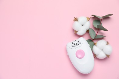 Photo of Modern epilator, fluffy cotton flowers and eucalyptus branch on pink background, flat lay. Space for text