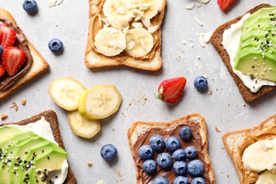 Photo of Tasty toast bread with fruits and berries on light background