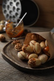 Freshly baked homemade walnut shaped cookies with condensed milk on wooden table