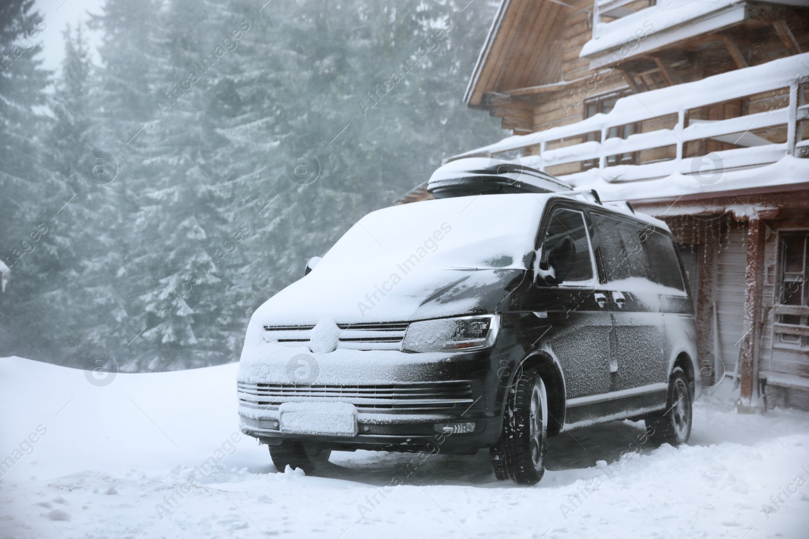 Photo of Modern car covered in snow outdoors on winter day