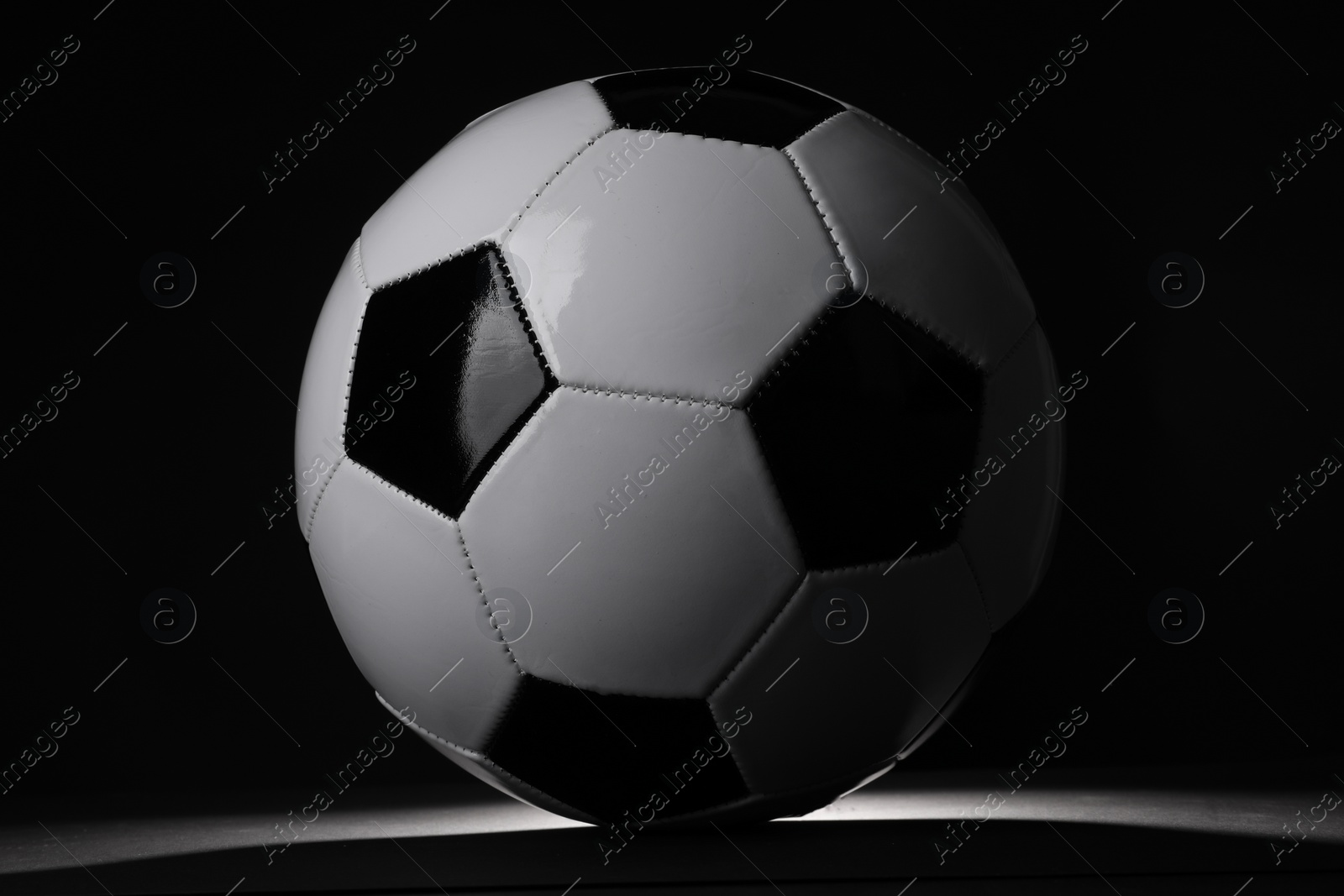 Photo of One soccer ball in darkness. Sports equipment